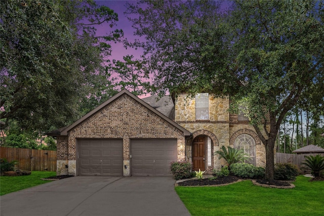 view of front of home with a lawn and a garage