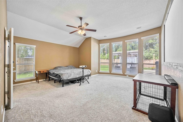 bedroom with carpet flooring, a textured ceiling, ceiling fan, and lofted ceiling