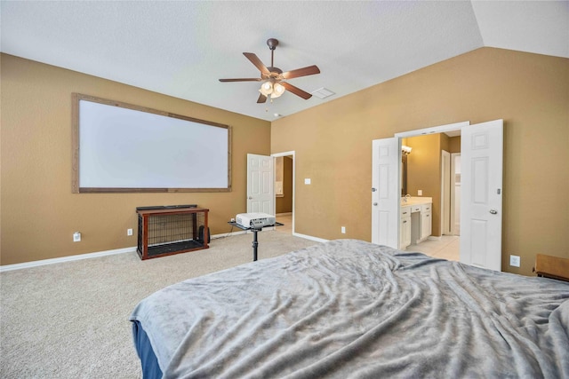 carpeted bedroom featuring ensuite bath, ceiling fan, and lofted ceiling