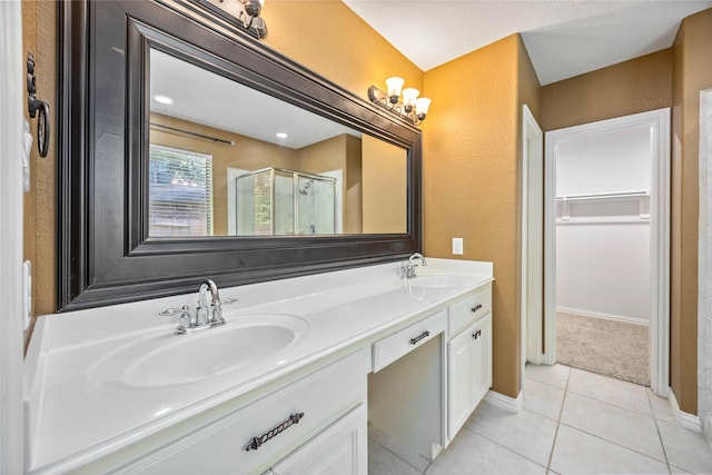 bathroom with vanity, tile patterned floors, and a shower with shower door