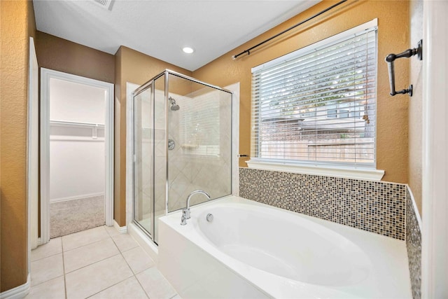 bathroom with tile patterned floors and independent shower and bath