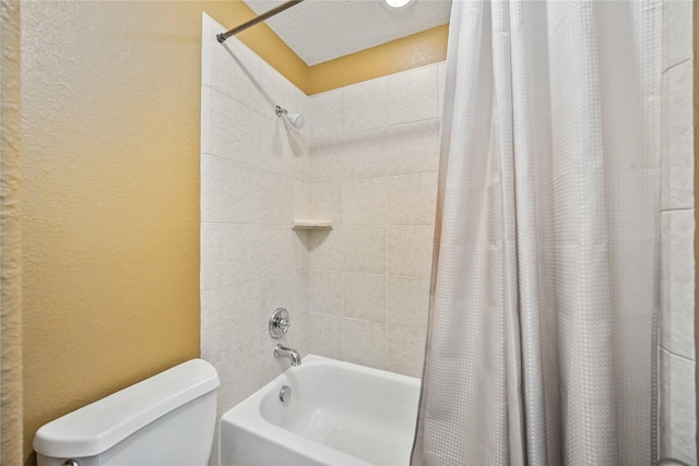 bathroom with shower / tub combo, a textured ceiling, and toilet