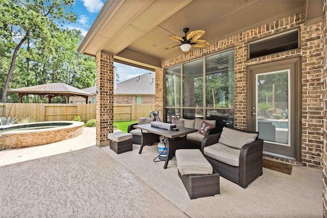 view of patio featuring an outdoor hangout area, ceiling fan, and an outdoor hot tub