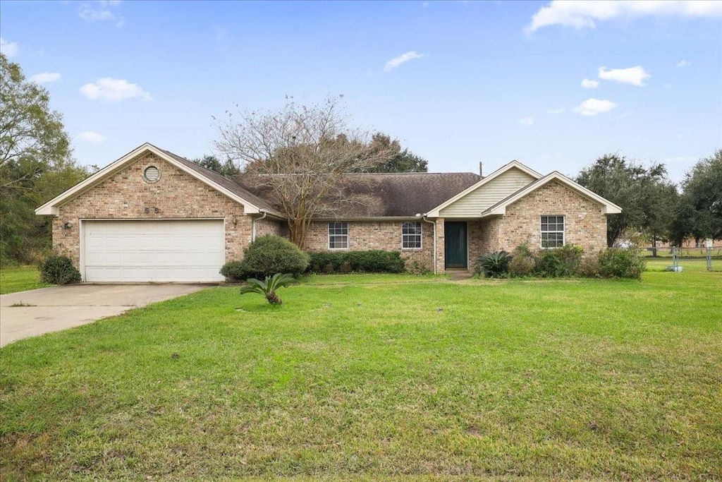 ranch-style home with a garage and a front yard