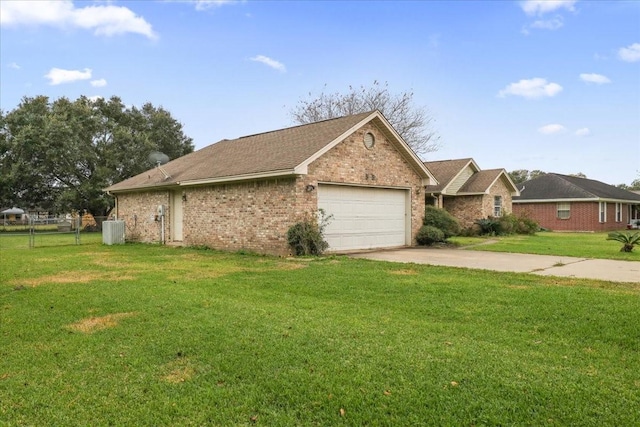 ranch-style home with cooling unit, a front yard, and a garage