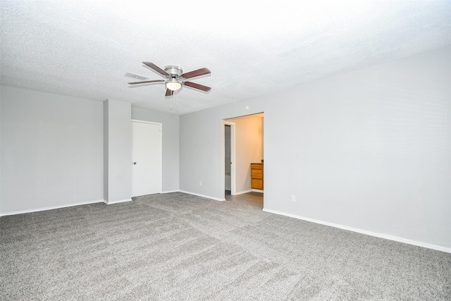 carpeted empty room featuring ceiling fan and a textured ceiling