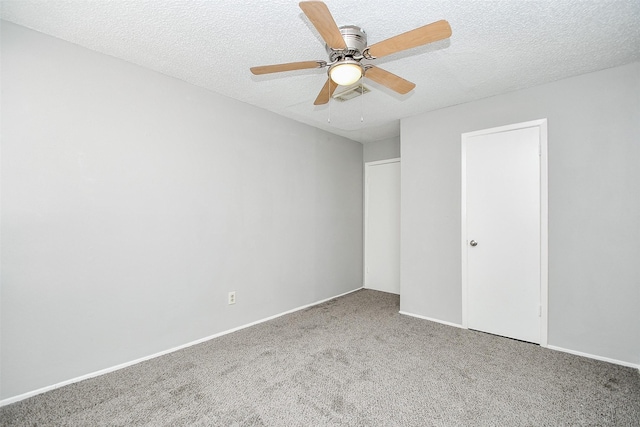 unfurnished bedroom featuring ceiling fan, a closet, carpet, and a textured ceiling