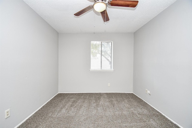 carpeted empty room with ceiling fan and a textured ceiling