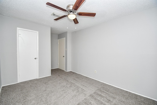 unfurnished bedroom with carpet, ceiling fan, a textured ceiling, and a closet