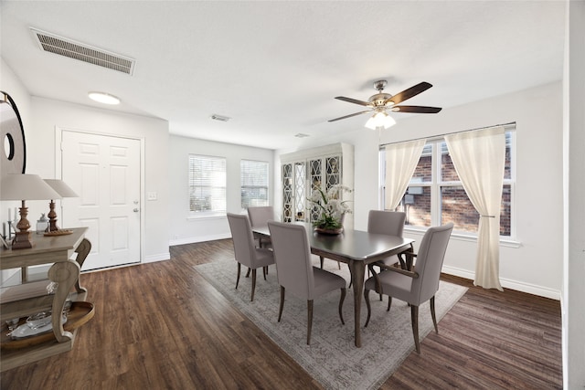 dining area featuring ceiling fan and dark wood-type flooring