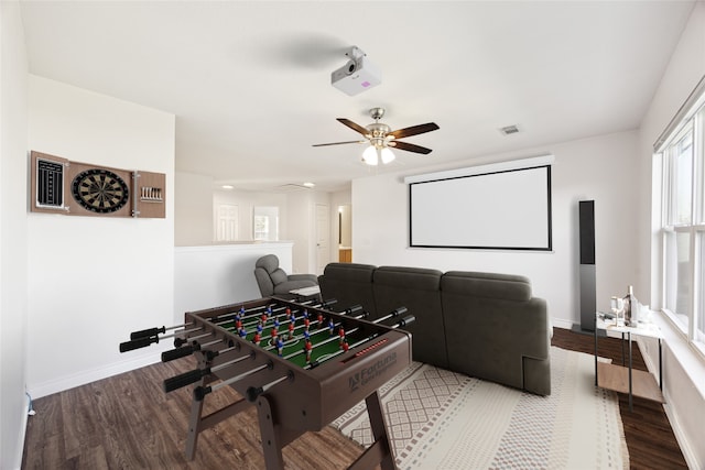 cinema featuring ceiling fan and wood-type flooring