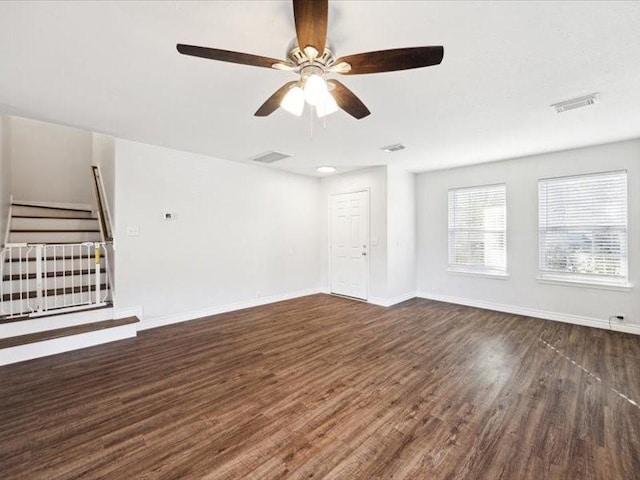 unfurnished living room featuring ceiling fan and dark hardwood / wood-style floors