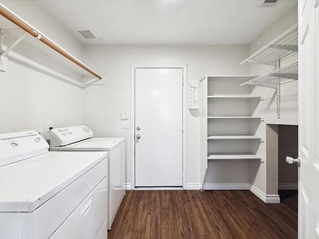 clothes washing area featuring washer and dryer and dark hardwood / wood-style floors