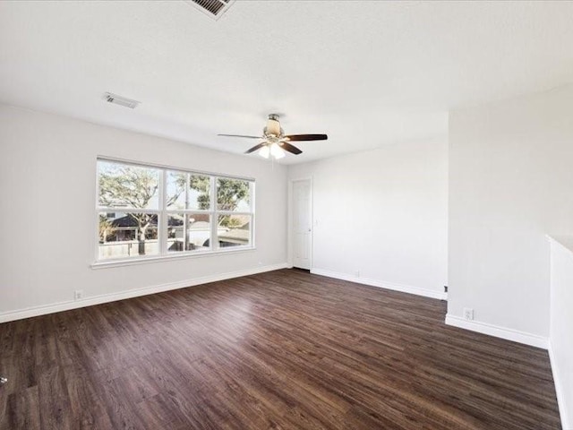 empty room featuring dark hardwood / wood-style flooring and ceiling fan