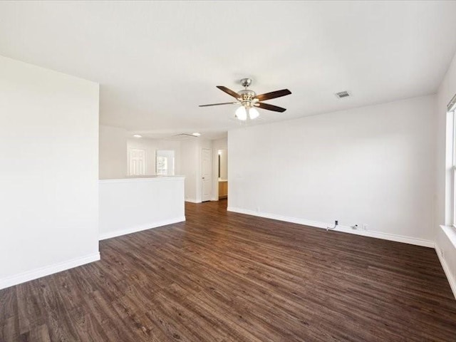 unfurnished room featuring ceiling fan and dark wood-type flooring