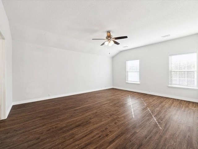 unfurnished room featuring ceiling fan, dark hardwood / wood-style flooring, and vaulted ceiling