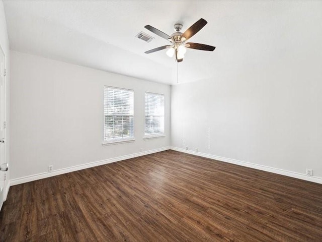 spare room featuring ceiling fan and dark hardwood / wood-style flooring