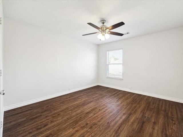 unfurnished room with ceiling fan and dark hardwood / wood-style flooring