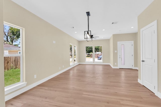 unfurnished living room with ceiling fan and light hardwood / wood-style floors