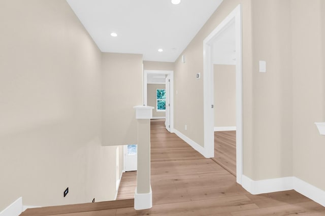 corridor with light hardwood / wood-style flooring