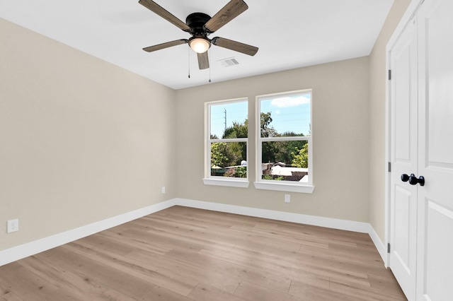 spare room featuring ceiling fan and light wood-type flooring