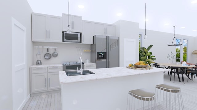 kitchen with light stone countertops, built in microwave, sink, pendant lighting, and stainless steel fridge with ice dispenser