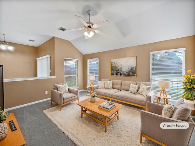 living room featuring ceiling fan, vaulted ceiling, and dark colored carpet