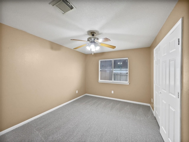 unfurnished bedroom with carpet flooring, ceiling fan, and a closet