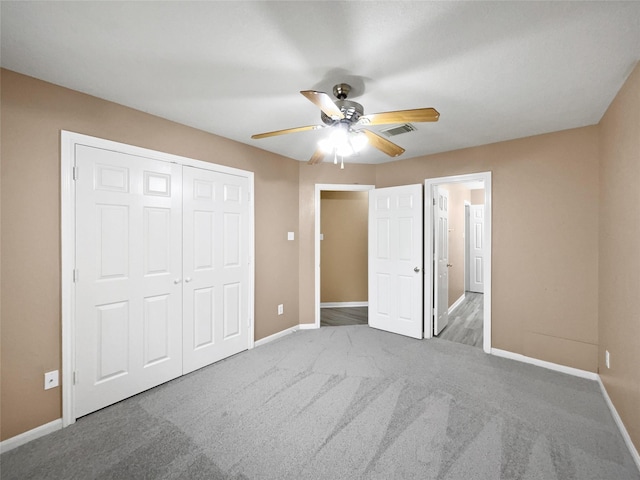 unfurnished bedroom with ceiling fan, a closet, and carpet