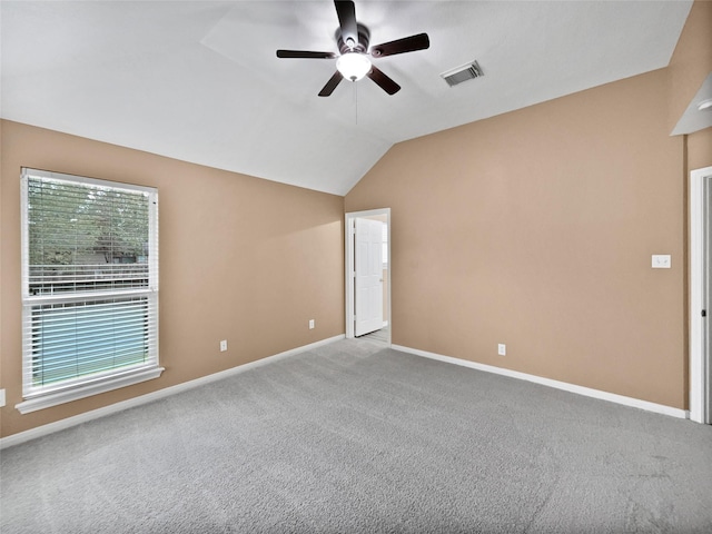 carpeted spare room with ceiling fan and lofted ceiling