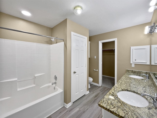 full bathroom featuring hardwood / wood-style flooring, vanity, toilet, and shower / bath combination