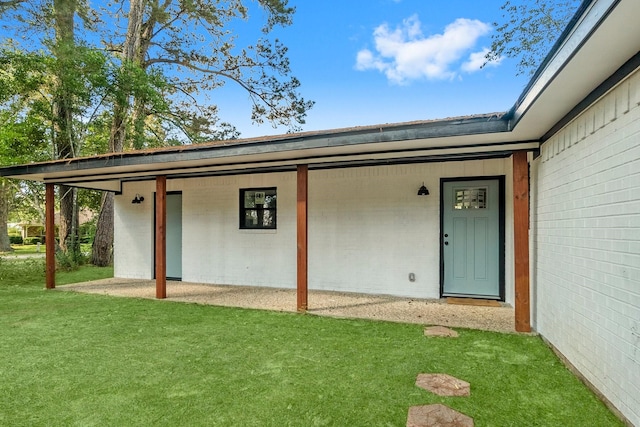 doorway to property featuring a yard