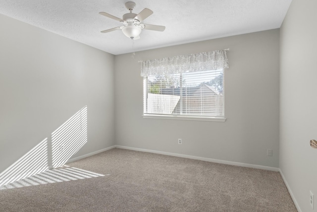 empty room with light carpet, a textured ceiling, and ceiling fan