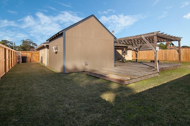 back of house with a pergola, a deck, and a lawn