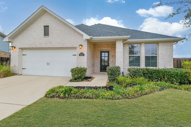 view of front of house with a front lawn and a garage