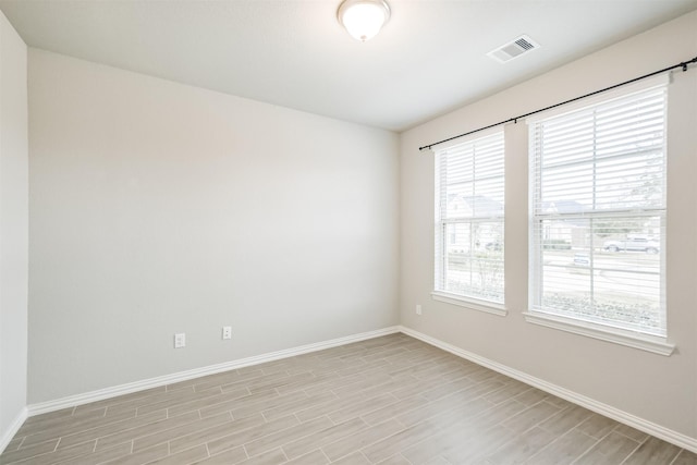 spare room with light hardwood / wood-style floors