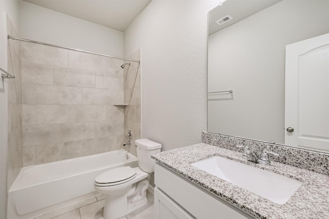 full bathroom with vanity, tile patterned floors, tiled shower / bath combo, and toilet