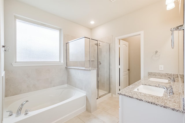 bathroom featuring tile patterned flooring, vanity, and shower with separate bathtub