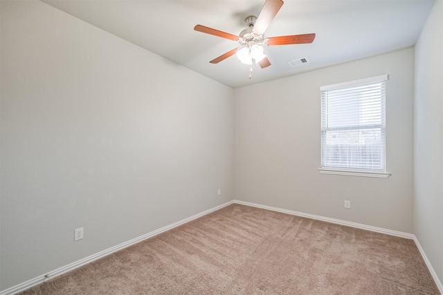 spare room with light carpet and ceiling fan