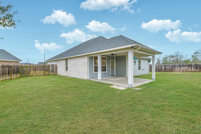 back of house with ceiling fan, a patio area, and a yard