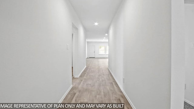 hallway with light hardwood / wood-style floors