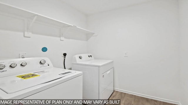 washroom with separate washer and dryer and dark wood-type flooring