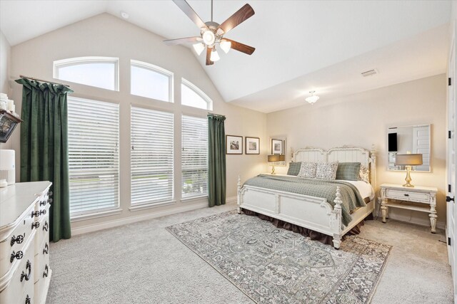 carpeted bedroom featuring ceiling fan, vaulted ceiling, and multiple windows