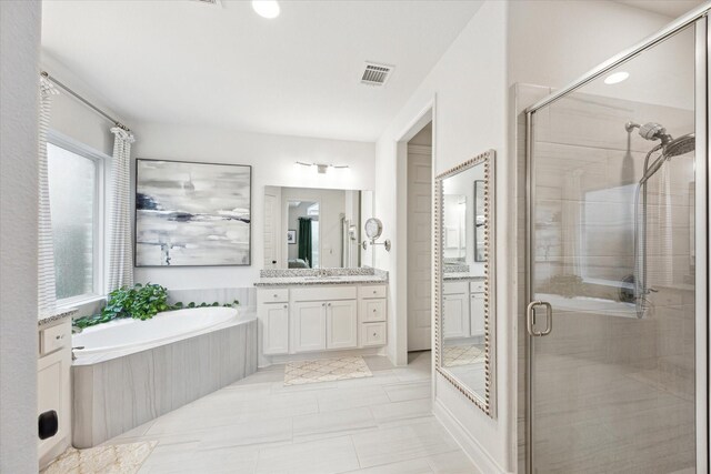 bathroom with tile patterned flooring, vanity, and shower with separate bathtub