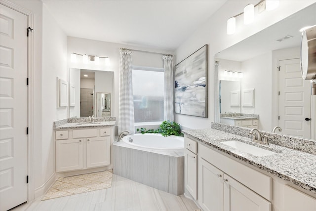 bathroom featuring separate shower and tub and vanity