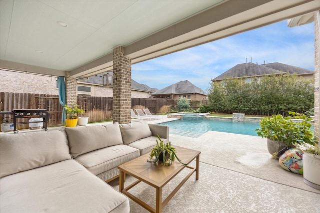 view of pool featuring grilling area, an in ground hot tub, an outdoor living space, and a patio