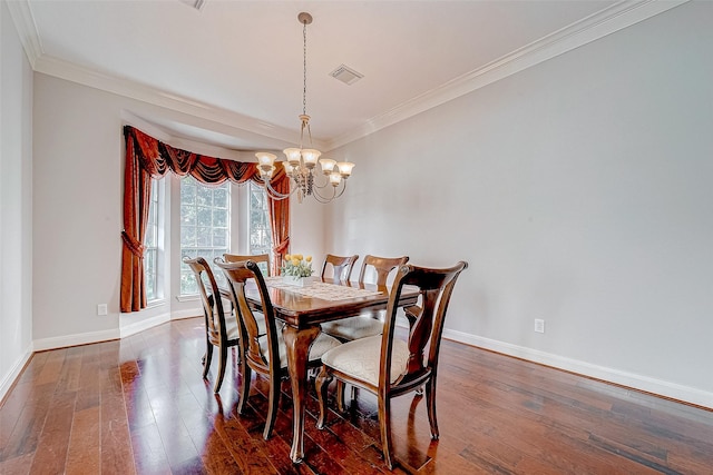 dining area featuring dark hardwood / wood-style flooring, a chandelier, and ornamental molding