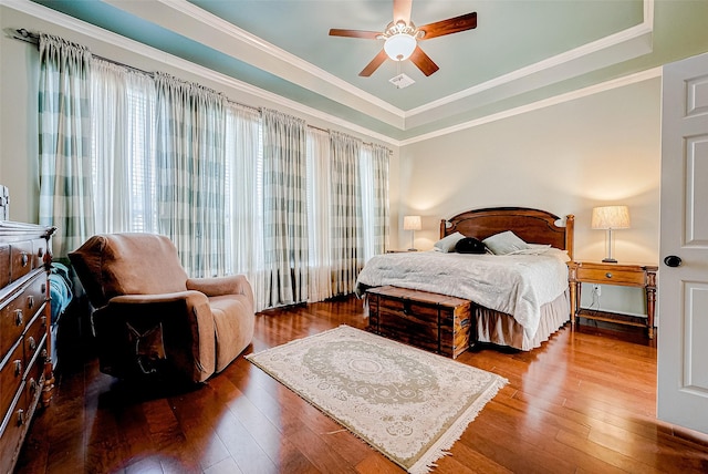 bedroom with ceiling fan, crown molding, and wood-type flooring