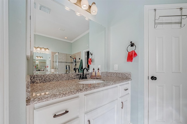 bathroom featuring an enclosed shower, vanity, and crown molding