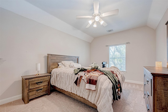 carpeted bedroom with ceiling fan and vaulted ceiling